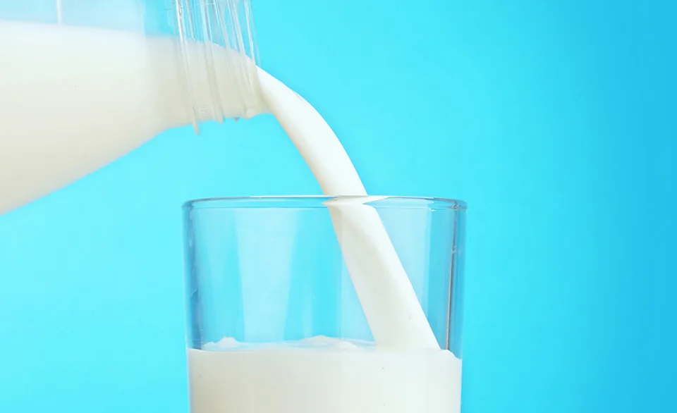 milk being poured into a glass