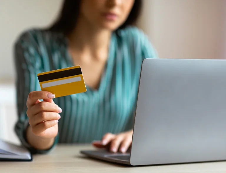 woman with credit card at laptop