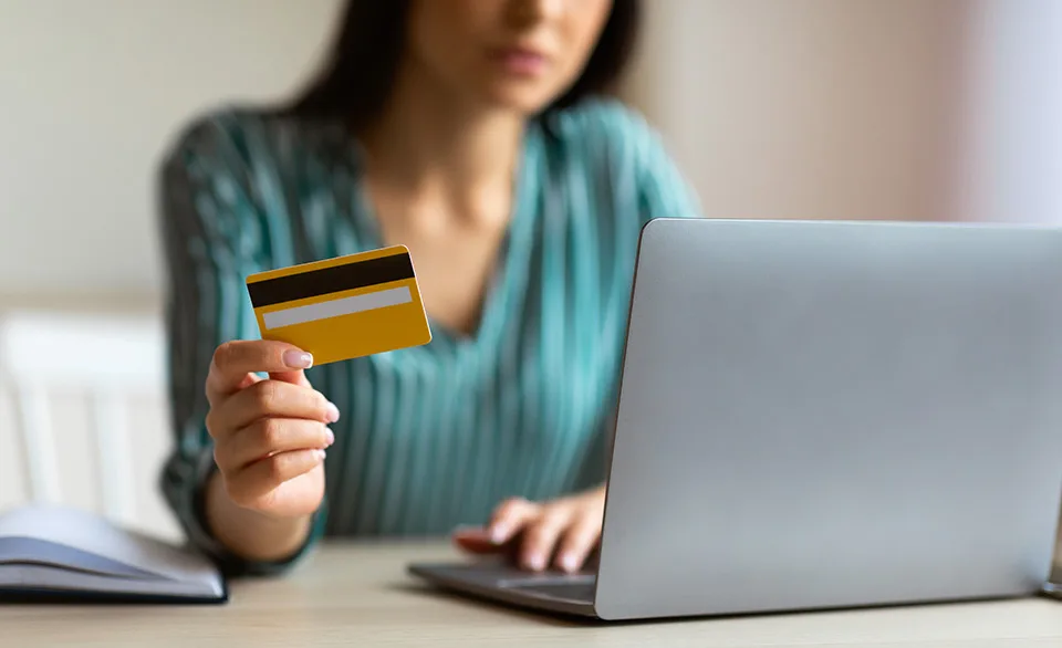 woman with credit card at laptop