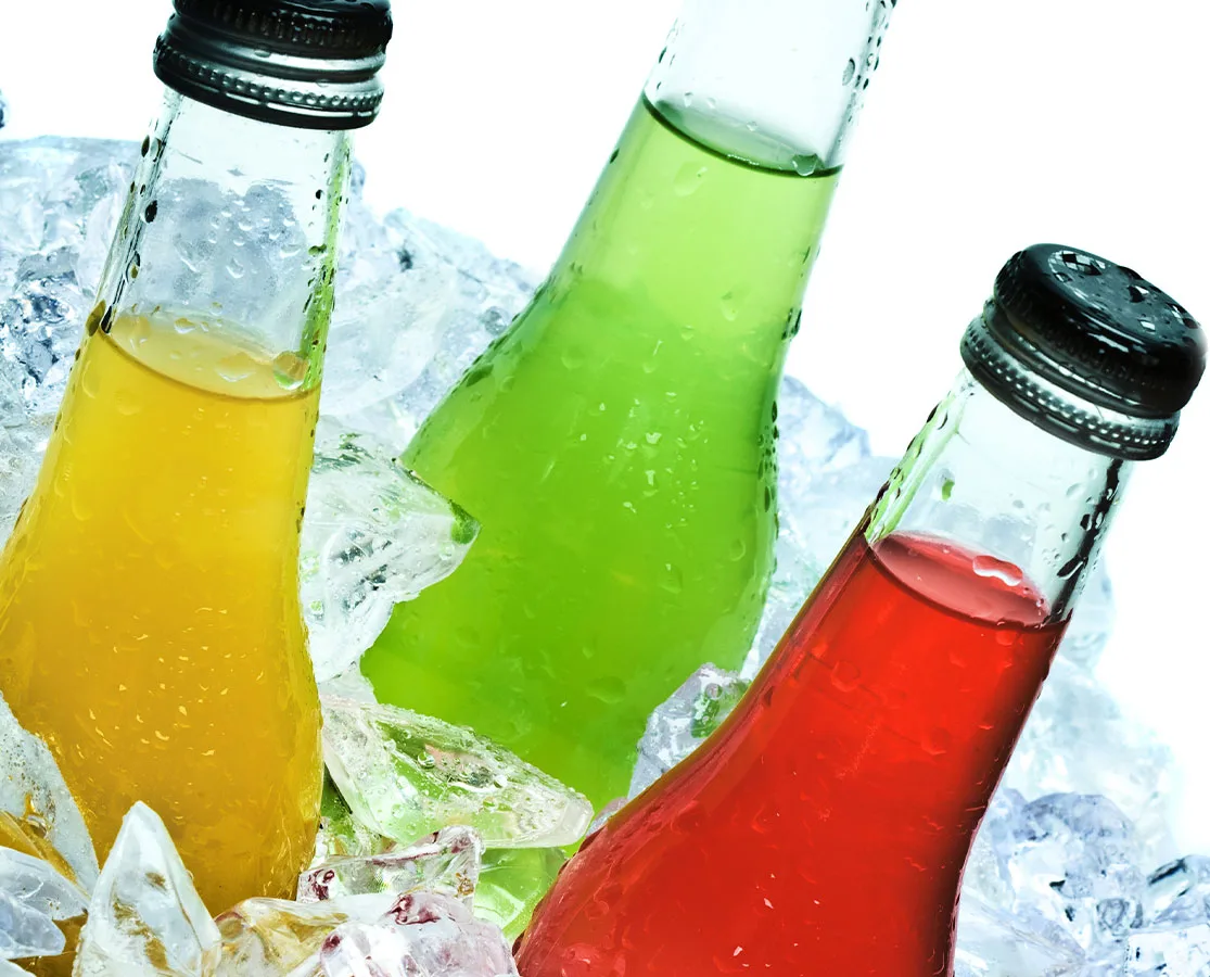 bottles of yellow, red and green soda