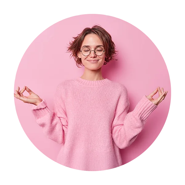 woman in pink meditating and smiling